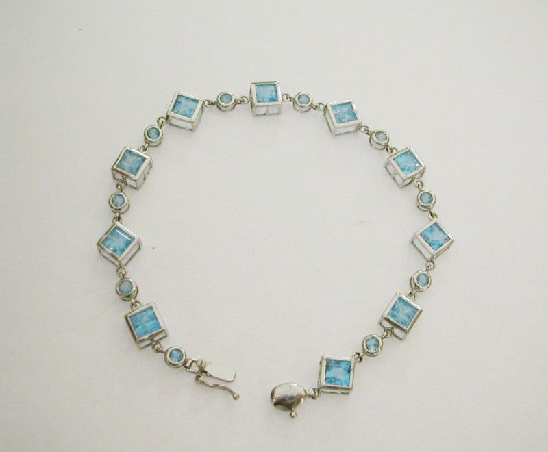 Ladies 10k white gold bracelet with Blue Topaz Gems  